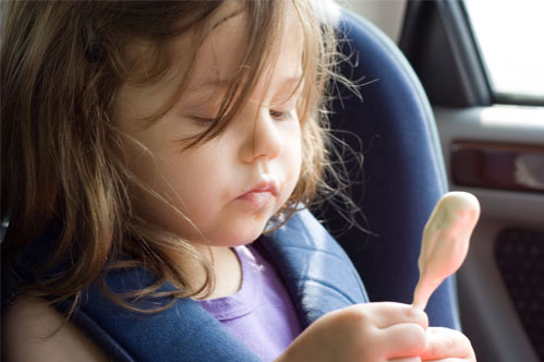 girl eating ice cream in car
